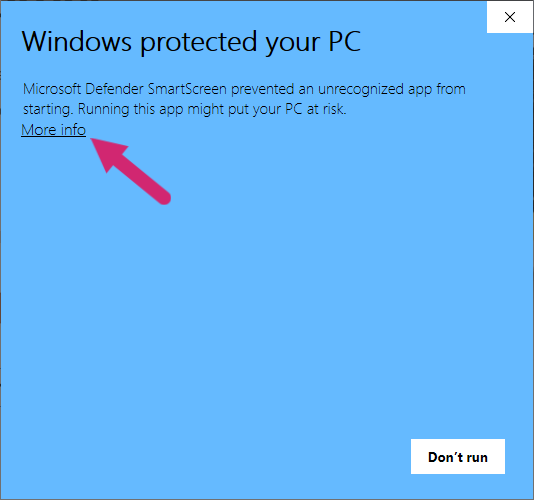 Windows SmartScreen warning dialog with a red arrow pointing at the 'More info' link